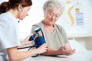 senior woman getting blood pressure checked